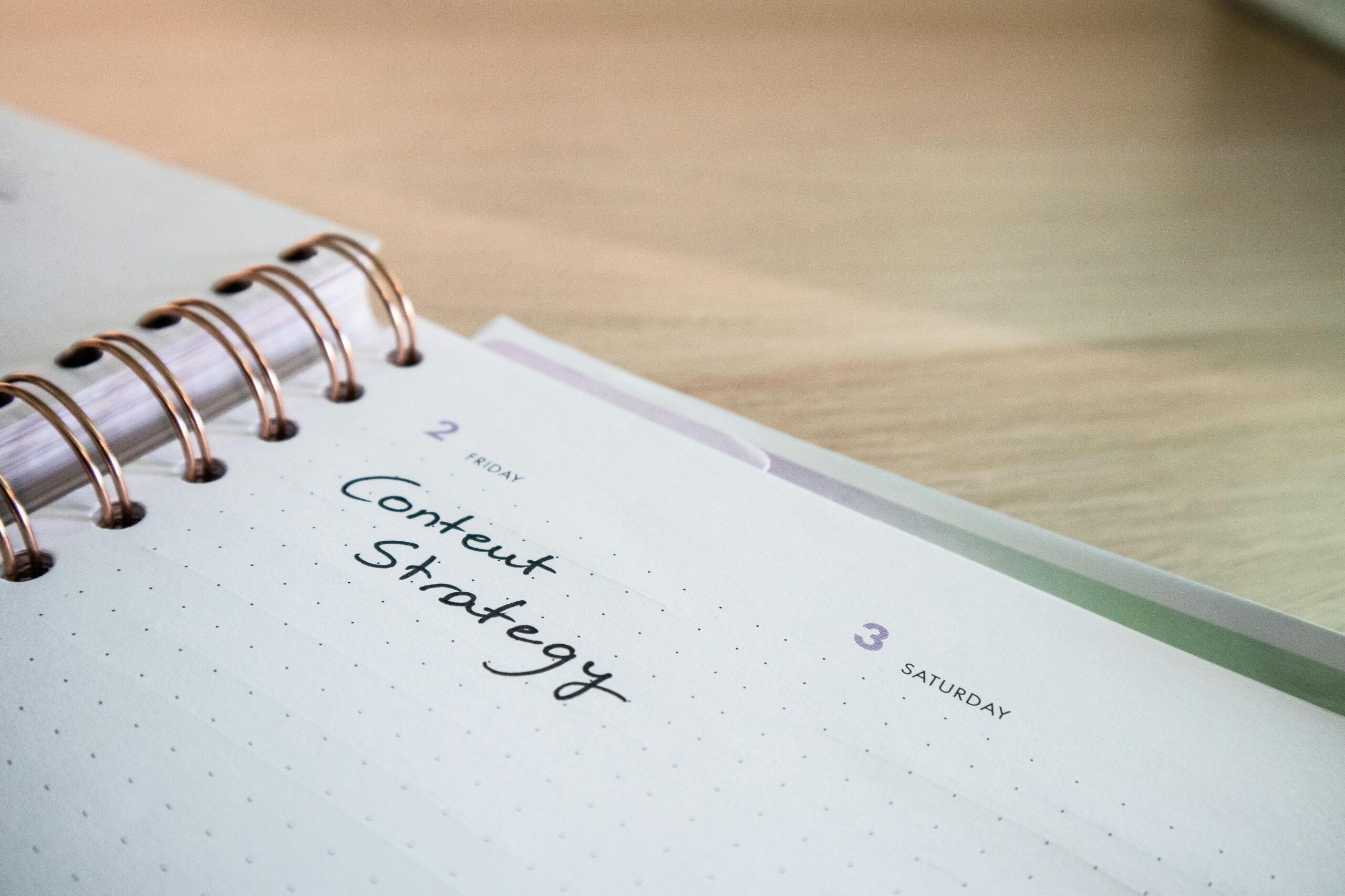 Close-up of a notebook page with 'Content Strategy' written on it, ideal for business planning visuals.